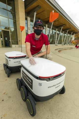 A University of Wisconsin student with the Starship robot