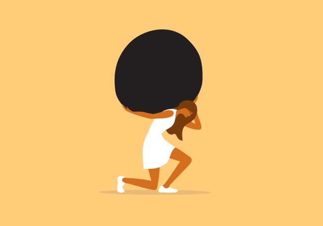 Concept image of a casually dressed woman kneeling under the weight of a large boulder she's trying to carry on her back. Tones are yellow, white and black.
